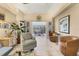 Open concept living room area with tile floors, an accent chair, plants, and an open view to the sunroom at 4579 Del Sol S Blvd, Sarasota, FL 34243
