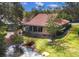A sunny view from the home showcasing the backyard and waterside property at 4579 Del Sol S Blvd, Sarasota, FL 34243