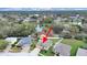 Stunning aerial view of home, highlighting lush surroundings, pond, and neighborhood at 4644 Braesgate Ct, Land O Lakes, FL 34639