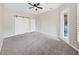 Relax in this bedroom offering space, natural lighting, a ceiling fan and a stylish barn door leading to the ensuite at 4644 Braesgate Ct, Land O Lakes, FL 34639