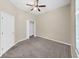 Neutral bedroom featuring carpet, a ceiling fan, and closet at 4644 Braesgate Ct, Land O Lakes, FL 34639