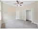 Neutral bedroom featuring carpet, closet, ceiling fan, and a door at 4644 Braesgate Ct, Land O Lakes, FL 34639