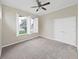 Peaceful bedroom featuring neutral carpet, ample natural light, and spacious closet at 4644 Braesgate Ct, Land O Lakes, FL 34639