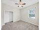 Cozy bedroom with a ceiling fan, closet, neutral carpet, and bright window at 4644 Braesgate Ct, Land O Lakes, FL 34639