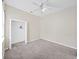Neutral bedroom featuring carpet, ceiling fan, closet, and a window at 4644 Braesgate Ct, Land O Lakes, FL 34639