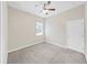 Neutral bedroom featuring plush carpet, a ceiling fan, and a window offering natural light at 4644 Braesgate Ct, Land O Lakes, FL 34639