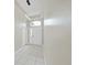 Bright entryway featuring tile flooring, a modern chandelier, and a view of the front door at 4644 Braesgate Ct, Land O Lakes, FL 34639