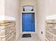 Welcoming front entrance featuring a vibrant blue door, stone accents, and tile flooring at 4644 Braesgate Ct, Land O Lakes, FL 34639