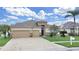 Charming home with a well-manicured lawn, lush landscaping, and a spacious three-car garage at 4644 Braesgate Ct, Land O Lakes, FL 34639
