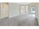 The neutral-toned living room leads to a tiled hallway, creating a warm and inviting atmosphere at 4644 Braesgate Ct, Land O Lakes, FL 34639