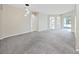 Spacious living room with neutral carpet, abundant natural light, and open floor plan at 4644 Braesgate Ct, Land O Lakes, FL 34639