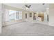 Open-concept living area featuring tile and carpet flooring, connecting kitchen and outdoor views at 4644 Braesgate Ct, Land O Lakes, FL 34639