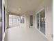 Covered porch with ample light and sliding door access to the home's interior at 4644 Braesgate Ct, Land O Lakes, FL 34639