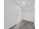Spacious walk-in closet with wire shelving, neutral carpet, and an ensuite bath through the doorway at 4644 Braesgate Ct, Land O Lakes, FL 34639