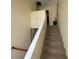 Carpeted staircase with simple railing and access to upstairs at 5034 Terrace Village Ln, Tampa, FL 33617