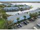 Aerial view showcasing waterfront condos with boat slips, and ample parking, complemented by meticulously maintained landscaping at 5075 Starfish Se Dr # B, St Petersburg, FL 33705