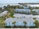 Aerial view of waterfront condos with boat slips, a community pool, and well-maintained landscaping near the bay at 5075 Starfish Se Dr # B, St Petersburg, FL 33705