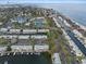Aerial shot of a waterfront community featuring boat docks, a pool, and nearby tennis courts at 5075 Starfish Se Dr # B, St Petersburg, FL 33705