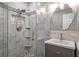 Bathroom featuring glass enclosed shower with marble-style tile and granite vanity at 5075 Starfish Se Dr # B, St Petersburg, FL 33705