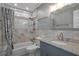 Bathroom featuring a shower-tub combination, granite vanity and decorative accents at 5075 Starfish Se Dr # B, St Petersburg, FL 33705