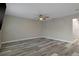 Spacious bedroom featuring wood laminate flooring, ceiling fan, and ample natural light at 5075 Starfish Se Dr # B, St Petersburg, FL 33705