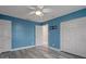 Bedroom features wood-look floors and ensuite bath with a ceiling fan at 5075 Starfish Se Dr # B, St Petersburg, FL 33705