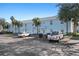 Exterior of the condo building with ample parking, palm trees, and well-maintained landscaping, providing a welcoming atmosphere at 5075 Starfish Se Dr # B, St Petersburg, FL 33705