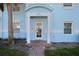Charming front entrance with a covered porch, brick pathway, and well-manicured landscaping and a glimpse of the unit's address at 5075 Starfish Se Dr # B, St Petersburg, FL 33705