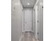 Hallway with modern flooring and neutral wall colors leads to other rooms in the home at 5075 Starfish Se Dr # B, St Petersburg, FL 33705