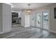 Bright living room featuring a view into the kitchen and access to a deck through glass doors, plus modern flooring at 5075 Starfish Se Dr # B, St Petersburg, FL 33705