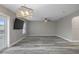 The spacious living room with modern flooring has outdoor access and is complemented by a ceiling fan at 5075 Starfish Se Dr # B, St Petersburg, FL 33705