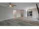 Open-concept living space featuring wood laminate flooring and a view of the kitchen at 5075 Starfish Se Dr # B, St Petersburg, FL 33705