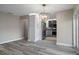 Open floor plan with kitchen view featuring modern flooring, recessed lights, and neutral wall colors at 5075 Starfish Se Dr # B, St Petersburg, FL 33705