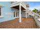 Brick patio with bright blue exterior walls, stairs leading to the second story, and a white fence at 5075 Starfish Se Dr # B, St Petersburg, FL 33705