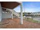 Spacious patio with brick pavers, white railings, and stairs leading to upper level near boat dock at 5075 Starfish Se Dr # B, St Petersburg, FL 33705