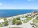 Scenic coastal property with sandy beach, palm trees, and beautiful waterfront homes at 5089 Royal Palms Way # 202, New Port Richey, FL 34652