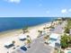 Expansive beach front view with shady picnic areas, parking, and clear blue ocean waters, perfect for relaxation at 5089 Royal Palms Way # 202, New Port Richey, FL 34652