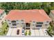 Aerial view of condo buildings with balconies, attached garages, and a red-tiled roof at 5089 Royal Palms Way # 202, New Port Richey, FL 34652