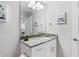 Bright bathroom with a large mirror and stylish vanity featuring a granite countertop at 5089 Royal Palms Way # 202, New Port Richey, FL 34652