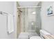 Bathroom with tiled shower, toilet, and towel rack at 5089 Royal Palms Way # 202, New Port Richey, FL 34652