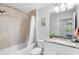 Bright bathroom featuring a granite vanity, tiled shower over tub, and neutral decor at 5089 Royal Palms Way # 202, New Port Richey, FL 34652