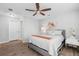 Bedroom with wood flooring, ceiling fan, and a comfortable bed at 5089 Royal Palms Way # 202, New Port Richey, FL 34652