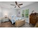 Bright bedroom with hardwood floors, a cozy bed, and vintage furniture, combining comfort with style at 5089 Royal Palms Way # 202, New Port Richey, FL 34652