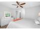 Bright bedroom with wood flooring, ceiling fan, and a comfortable bed at 5089 Royal Palms Way # 202, New Port Richey, FL 34652