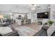 Spacious living room with kitchen views, ceiling fan, and natural light at 5089 Royal Palms Way # 202, New Port Richey, FL 34652