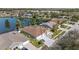 Beautiful lakefront home featuring a well-manicured lawn, screened-in patio, and convenient two-car garage at 5117 Spectacular Bid Dr, Wesley Chapel, FL 33544