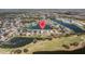 Aerial view of a lakeside community featuring a golf course and beautiful homes around the lake at 5117 Spectacular Bid Dr, Wesley Chapel, FL 33544