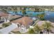 Waterfront home with a screened-in lanai, lush landscaping, and a three-car garage at 5117 Spectacular Bid Dr, Wesley Chapel, FL 33544