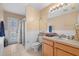 Bathroom featuring a single sink vanity, decorative window, walk-in shower with glass door at 5117 Spectacular Bid Dr, Wesley Chapel, FL 33544