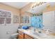 Bathroom featuring a single sink vanity, decorative window, and turtle shower curtain at 5117 Spectacular Bid Dr, Wesley Chapel, FL 33544